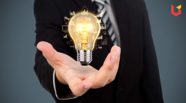 A Bulb in a man's hand depicting management of different ideas after doing Online MBA