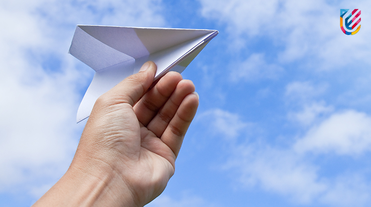 A hand is flying paper plane and dreaming to do MBA in Aviation Management